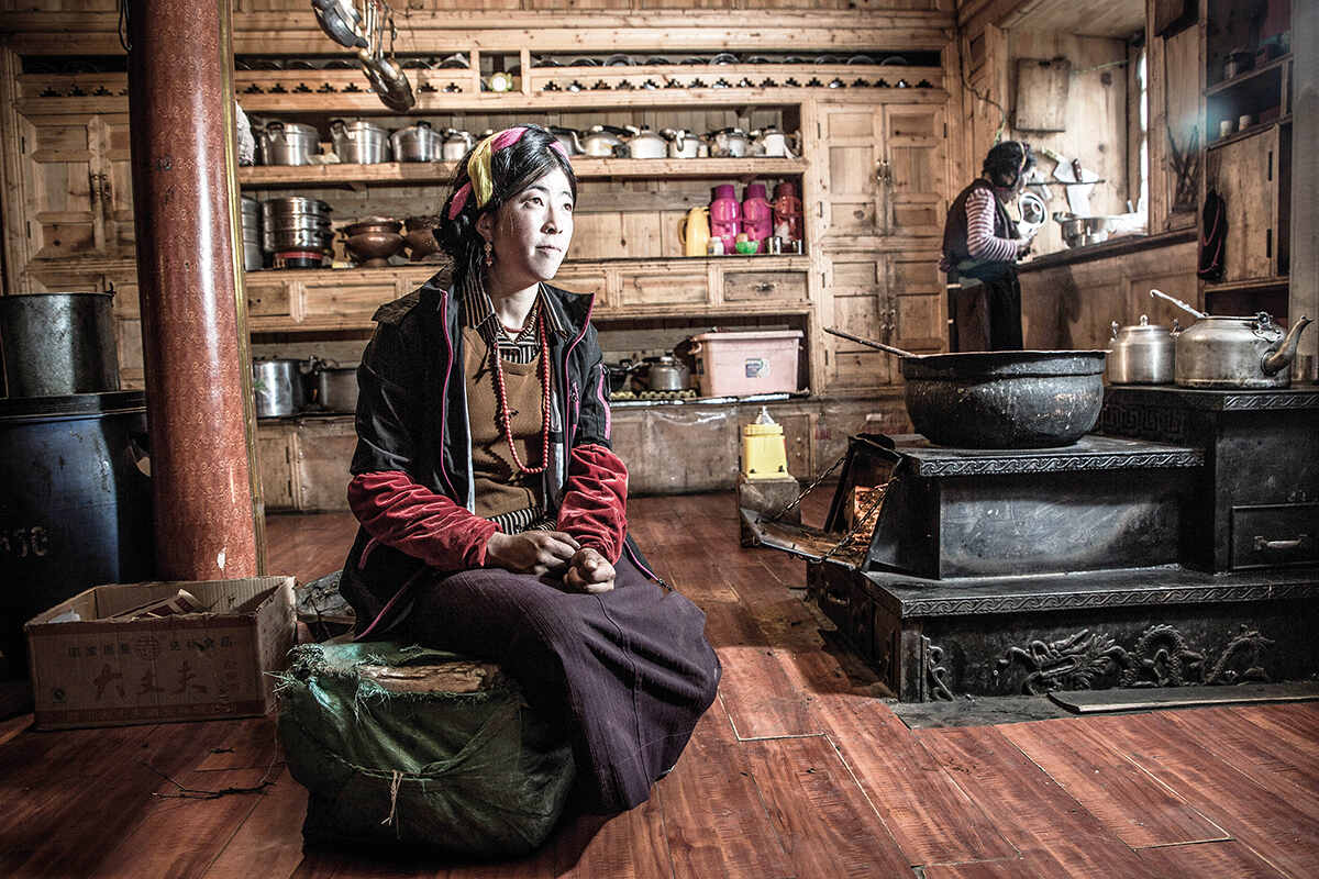 A Tibetan family in their home in a very remote region of eastern Tibet. The thick forests in this region are known to be home to bears