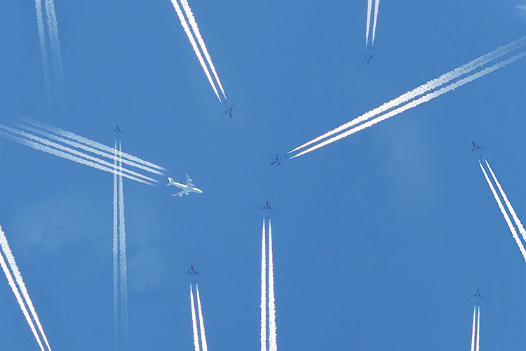 Airplanes and contrails in a blue sky