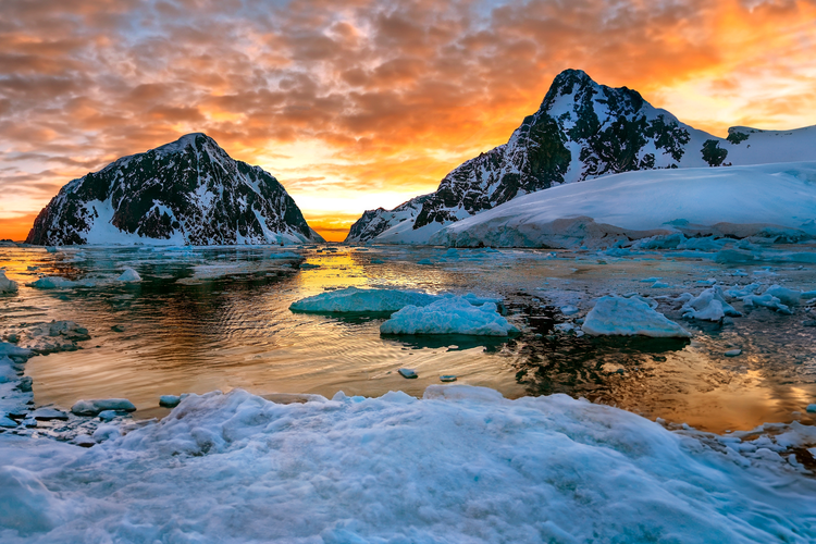 Midnight Sun and the entrance to the Lamaire Channel on the Antarctic Peninsula in Antarctica.