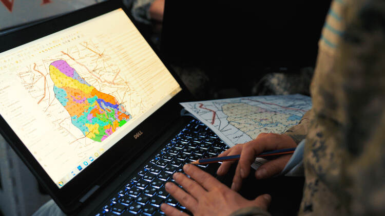 A laptop screen shows a map of a protected area