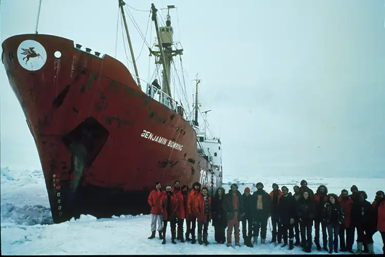 The Transglobe Expedition team stand in front of an icebound ship in the Arctic