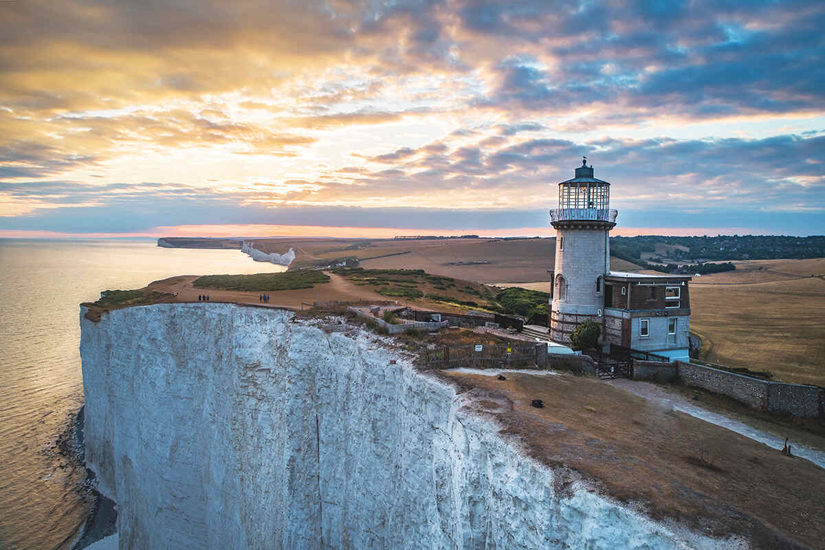 Sunset over beachy head with lighthouse and cliffs