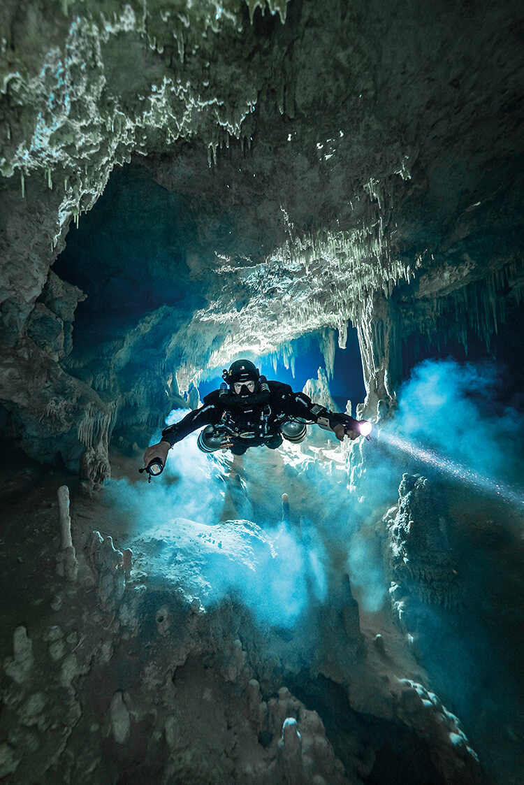 a cave diver penetrates Cenote Fenómeno, part of the Sac Actun-Dos Ojos system