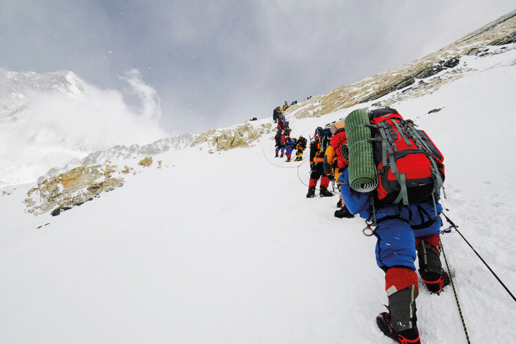 A line of climbers on the Lhotse Face (7,500 metres) crossing the Yellow Band, on the southeast route up Mount Everest in Nepal