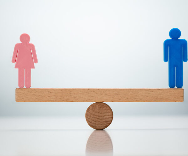 Male And Female Balancing On Seesaw