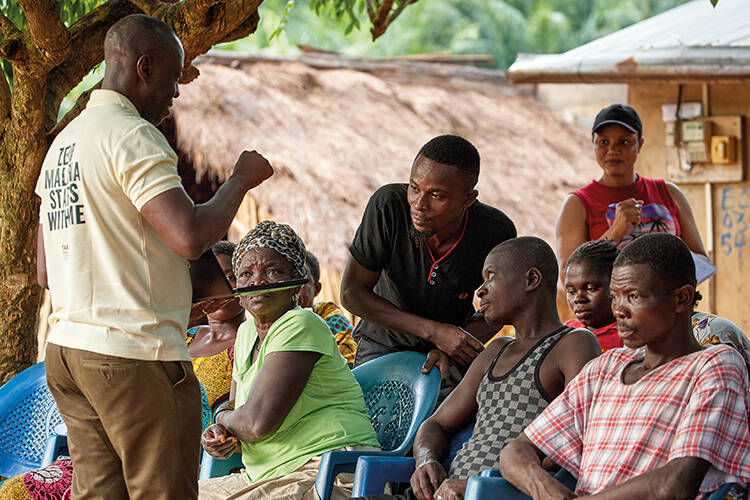 A Target Malaria team member engages with community members in the village of Abutia Amegame, Ghana