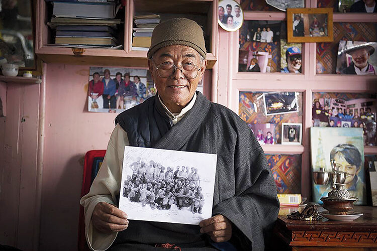 Kanchha Sherpa with a photograph of himself from the 1953 expedition