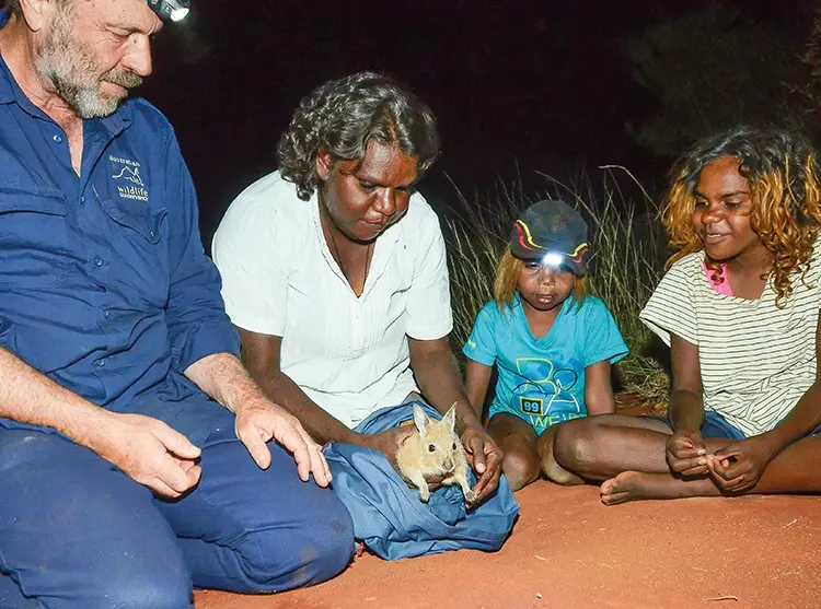 Rangers show local children the protected wildlife