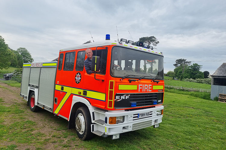 Nick Redmayne behind the wheel of the fire engine he is delivering to Ukraine