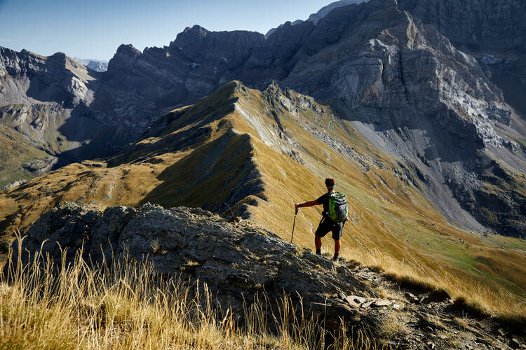 A hiker surveys the landscapes of the Pyrenees