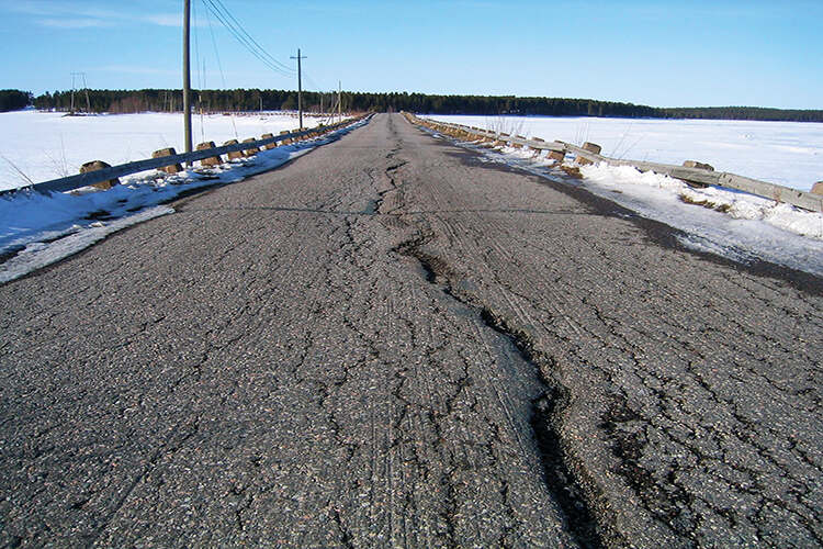 A road damaged by frost quakes in Finland