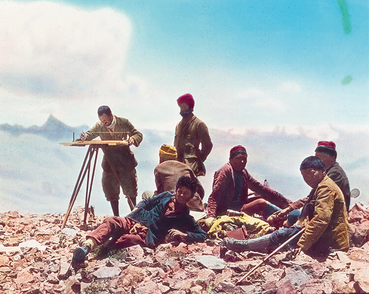 Henry Morshead plane tabling with Gujjar Singh (standing to his right) for the 1921 Mount Everest Reconnaissance Expedition. Morshead led the Great Trigonometrical Survey of India team. Photographed by CK Howard-Bury and hand-tinted by JB Noel