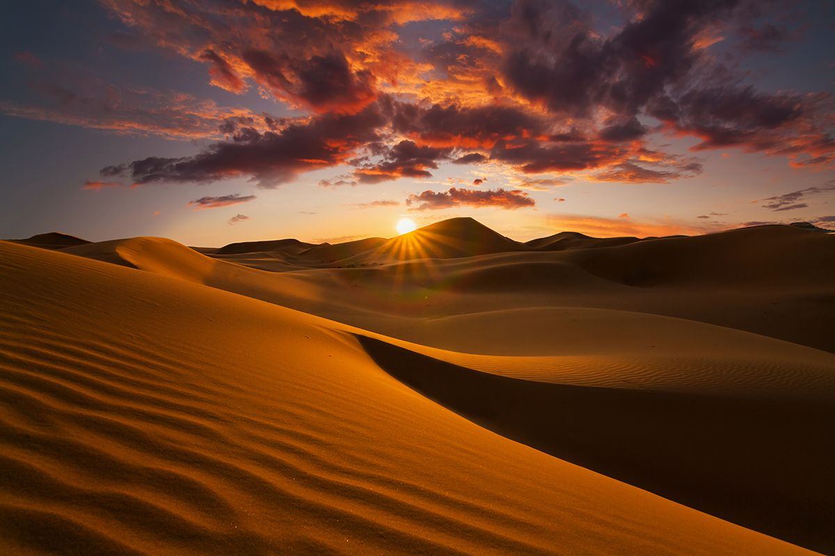 Sunset over Saharan sand dunes