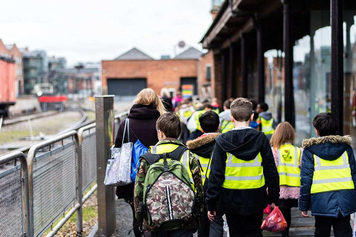 School children walking down a street in Manchester