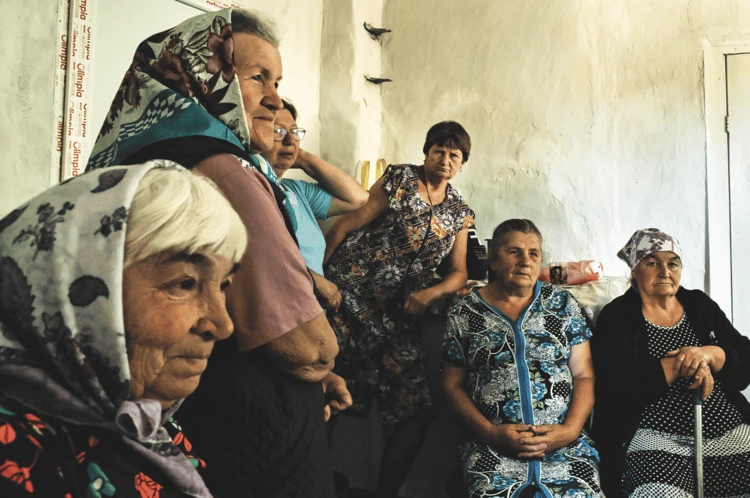 Women wait to see the doctor at the mobile clinic in Korbyni Ivani village, 12 kilometres from the front line. ‘We see missiles flying overhead, heading for Kharkiv every single day,’ says Katerina (in the blue dress). ‘We are so happy UK Med is here’