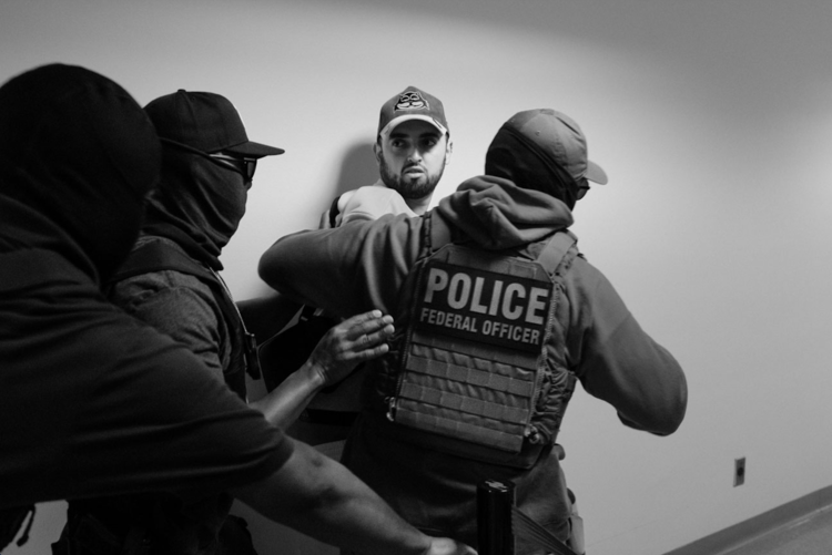 n A man is detained by ICE officers
after leaving a courtroom hearing at 26 Federal
Plaza. Detainees are frequently transferred to facilities in New Jersey, upstate New York or hundreds of miles away in the South and Midwest.