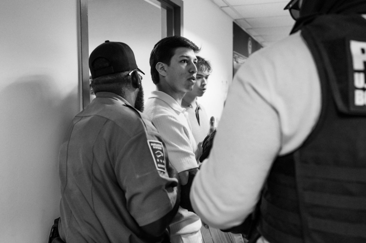 A young man is detained after his hearing. In 2025, fewer than 40 per cent of immigrants in removal proceedings had legal representation; this fell below 20 per cent once detainees were transferred to remote facilities.