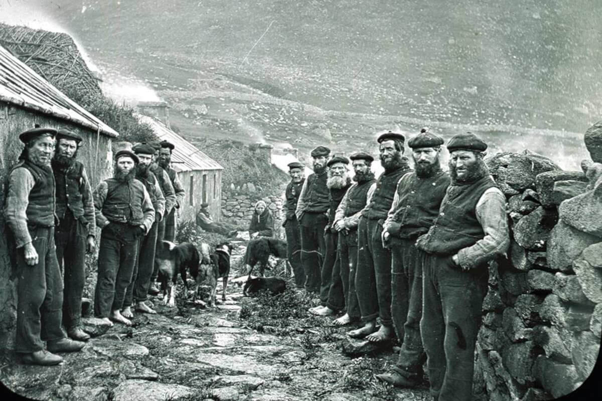 Men stand on either side of the street forming the St Kilda Parliament in the Village