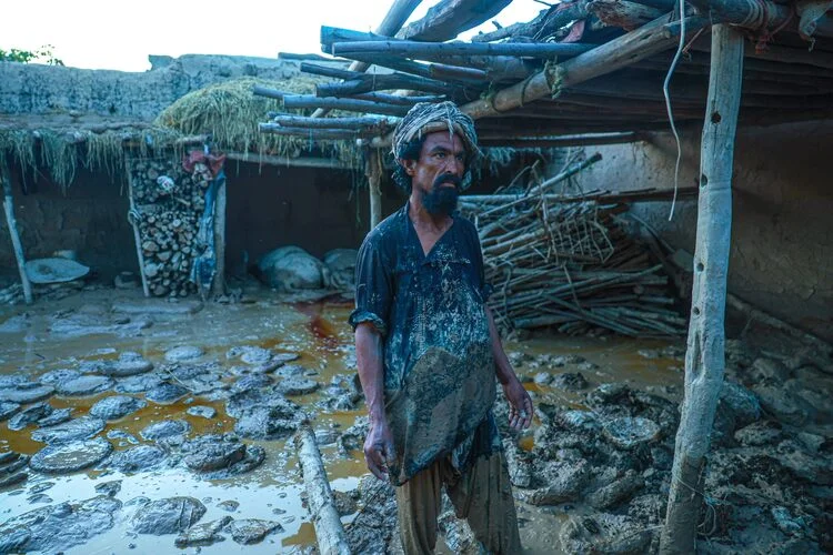 A man stands during a flood in Afghanistan, which destroyed homes and lives in Baghlan - May 13, 2024