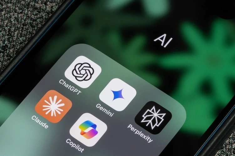 Portland, OR, USA - Nov 20, 2024: ChatGPT, Gemini, Microsoft Copilot, Claude, and Perplexity app icons are seen on the screen of an iPhone. Generative AI competition concepts.