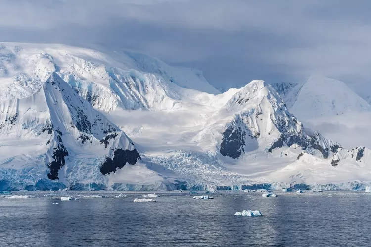 Glacier in Antarctica Wilhelmina Bay Beautiful Frozen Landscape. Wide Snow on Mountain Range. View from Cruise Ship Climate Change Melting Ice Caps