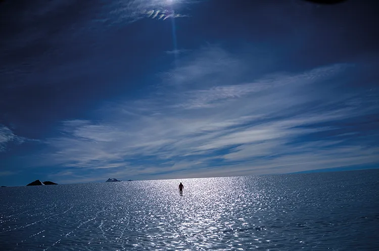 A research student walking out on the blue ice of Union Glacier