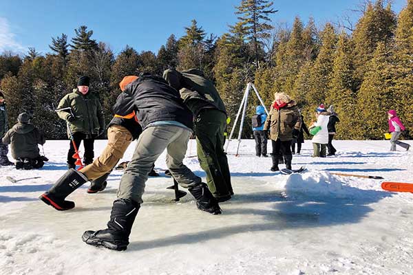 Researchers drilling into the ice of Crawford Lake to fine evidence of the anthropocene