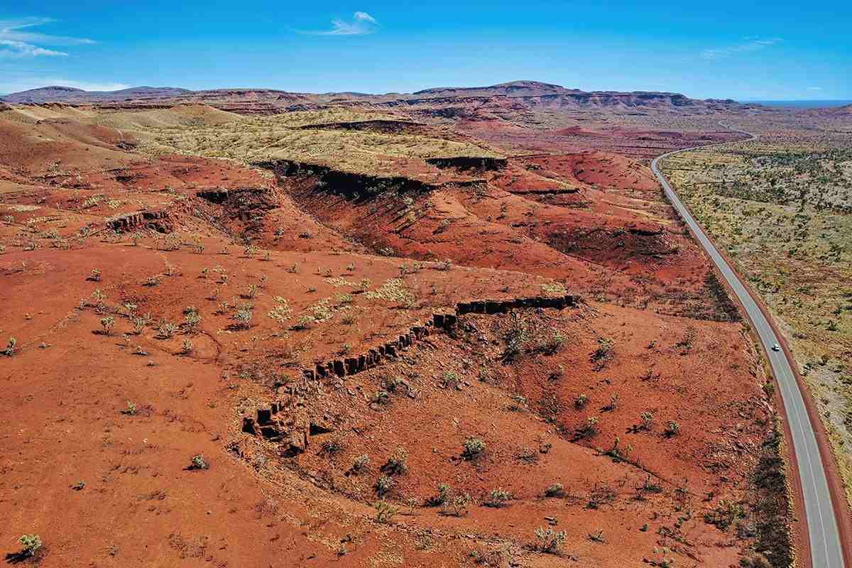 Landscape of australian desert with road running through in Pilbara, western australia