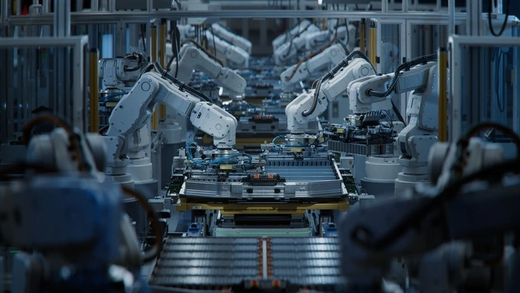 Row of White Robotic Arms at Automated Production Line at Factory.