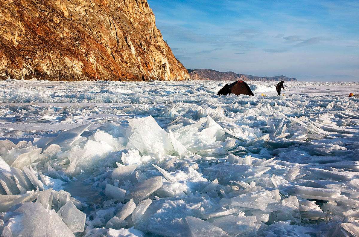 A tent and a figure can be seen among shards of ice emerging from Lake Baikal