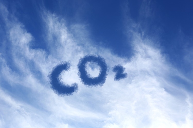 Blue sky with CO2 chemical formula and clouds. Carbon dioxide emissions