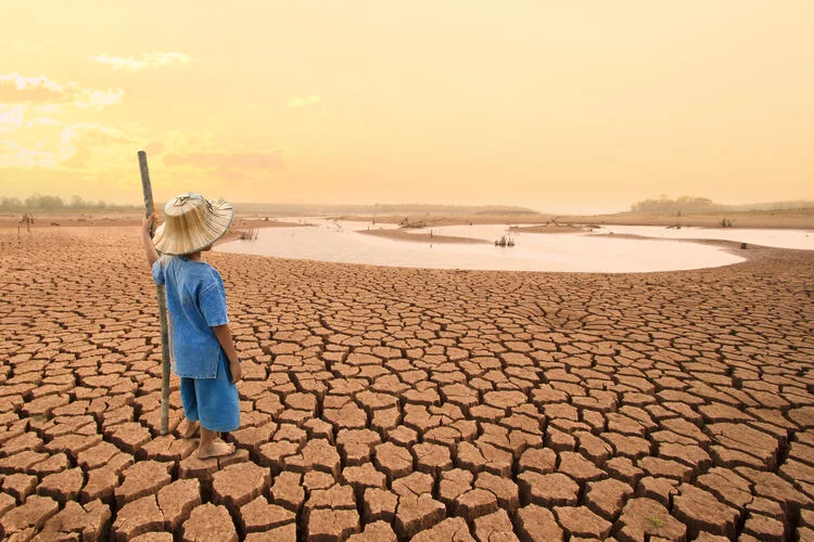 Children looking at drying river after Drought impact on summer.