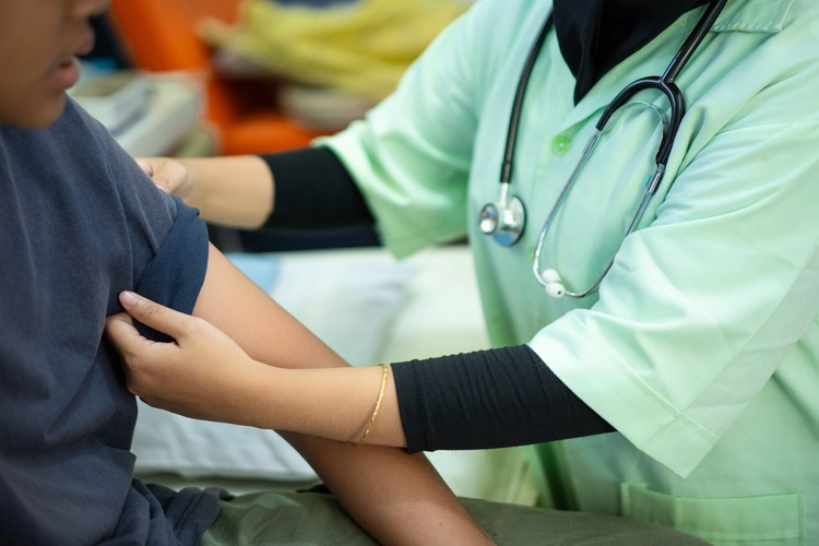 Close up of vaccination of patient by doctor.