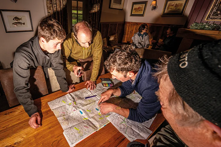 The team plots curlew sightings on a map during a pub planning meeting