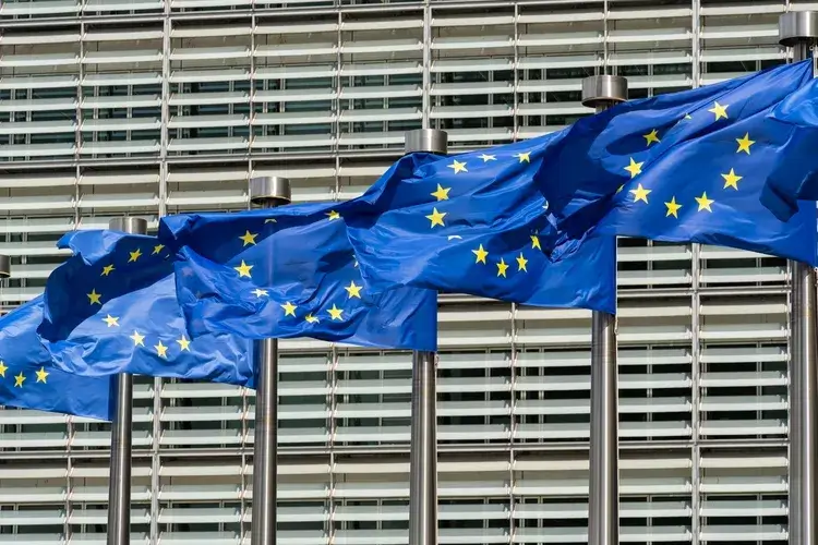 European Union Blue Flags and Berlaymont Building, Headquarters of the European Commission.