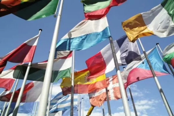 Numerous flags with sky in background