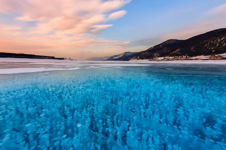 Bubbles of methane gas frozen into clear ice lake baikal, russia