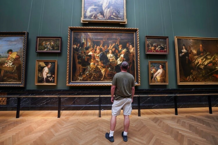 Vienna, Austria, EU - Sept. 2, 2023. Art lover enjoying the large paintings on the wall inside the Vienna art history museum.