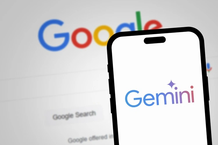 California, United States - May 21 2024: Google Gemini AI logo displayed on smartphone screen with Google Search in the background. Artificial intelligence chatbot developed by Google.