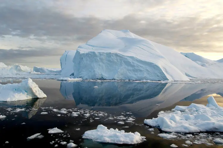 Front view of the terminus of Hisinger Glacier, Dickson Fiord, Northeast Greenland National Park. This is part of the Greenland Ice Sheet, and shows the glacial ice with reflection.