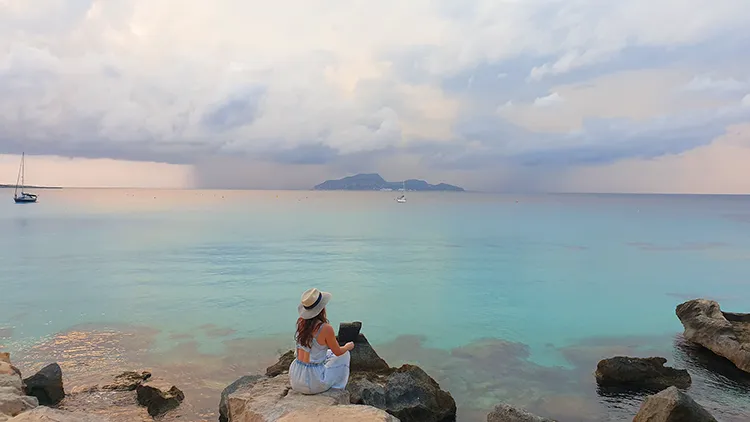 Laura looking back at mainland Sicily from Cala Rossa, Favignana