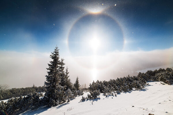 Ice halo around the sun in the sky in snowy lanscape