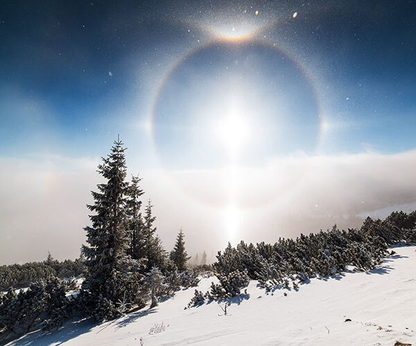 Ice halo around the sun in the sky in snowy lanscape