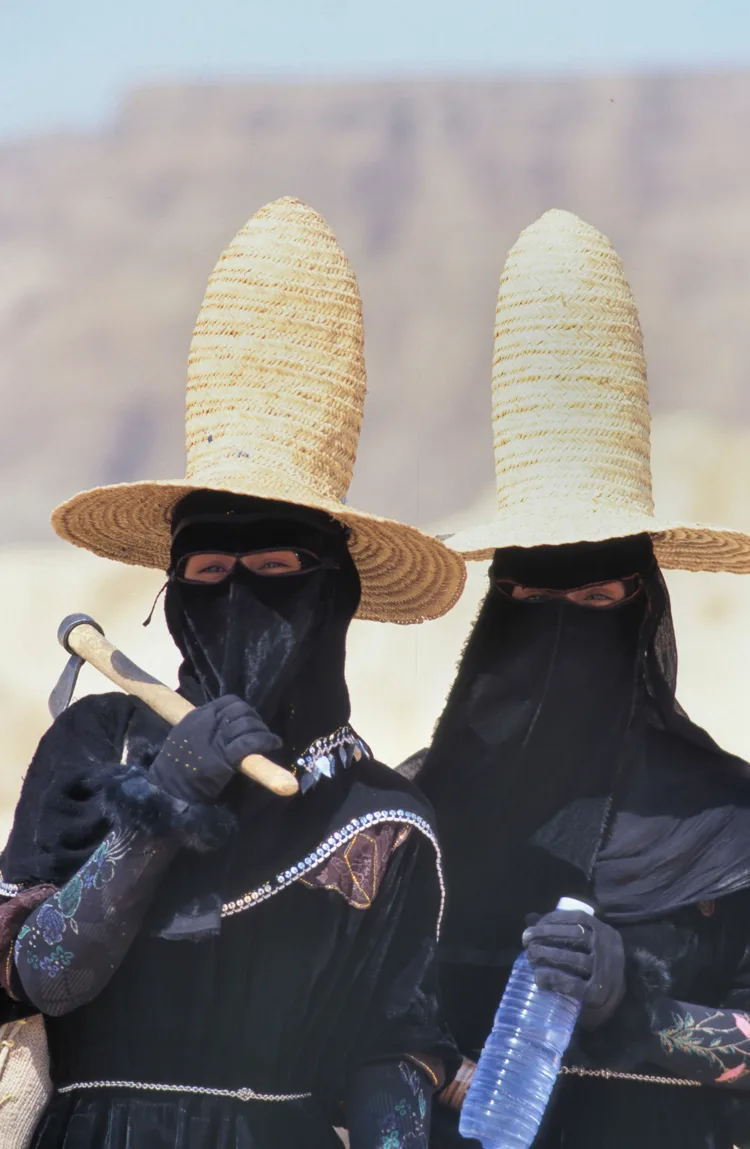 Two Yemeni women wearing tall straw hats