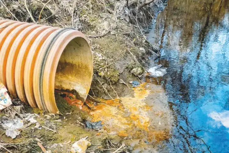 Industrial waste flowing into a waterway