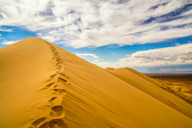 Khongor Sand Dunes in Gobi Desert in Mongolia with single footsteps in the sand