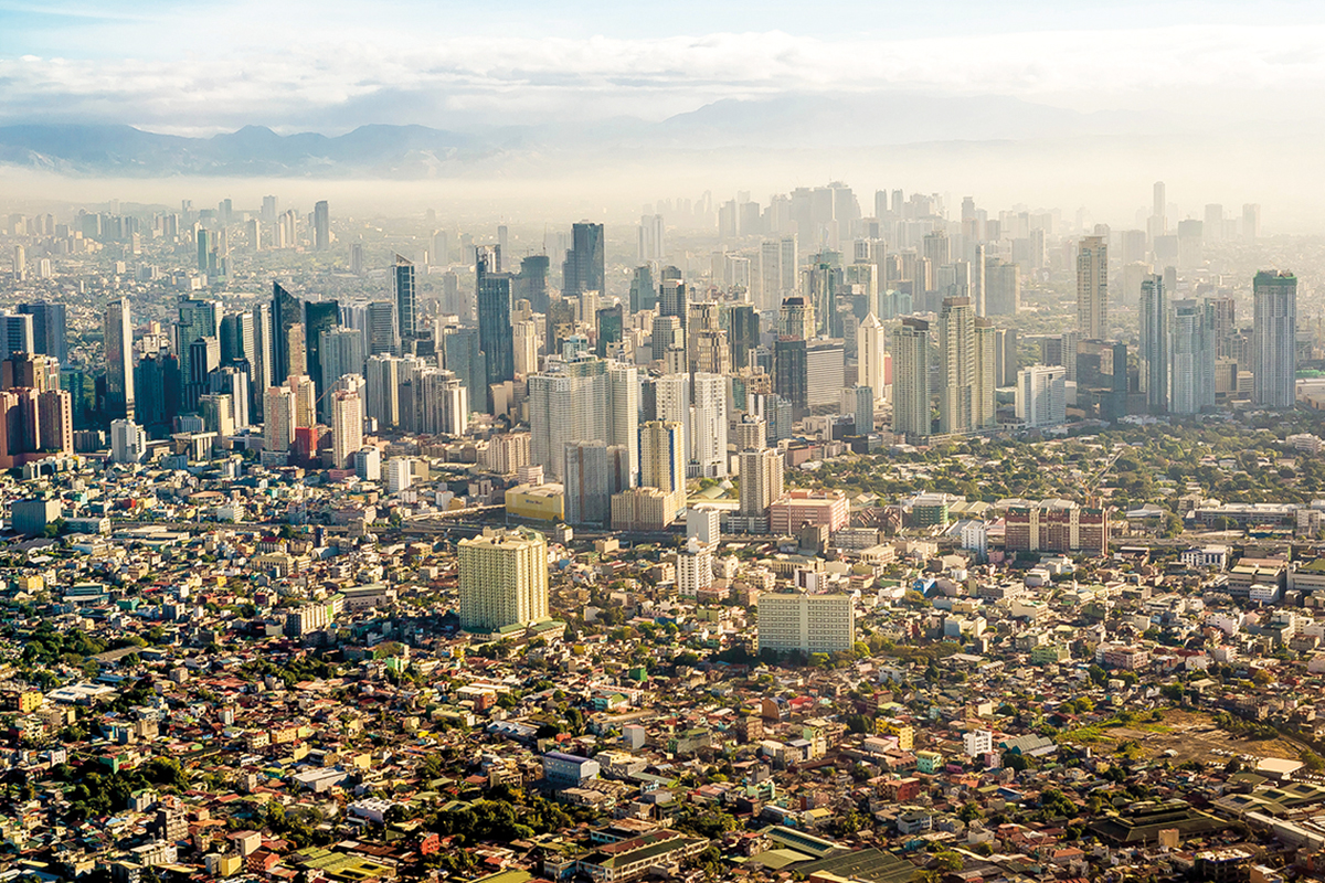 A landscape of the city of Manila with high rise buildings during the day