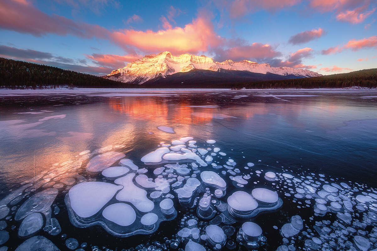 Bubbles of methane trapped in the ice on Minnewanka Lake, Alberta, Canada