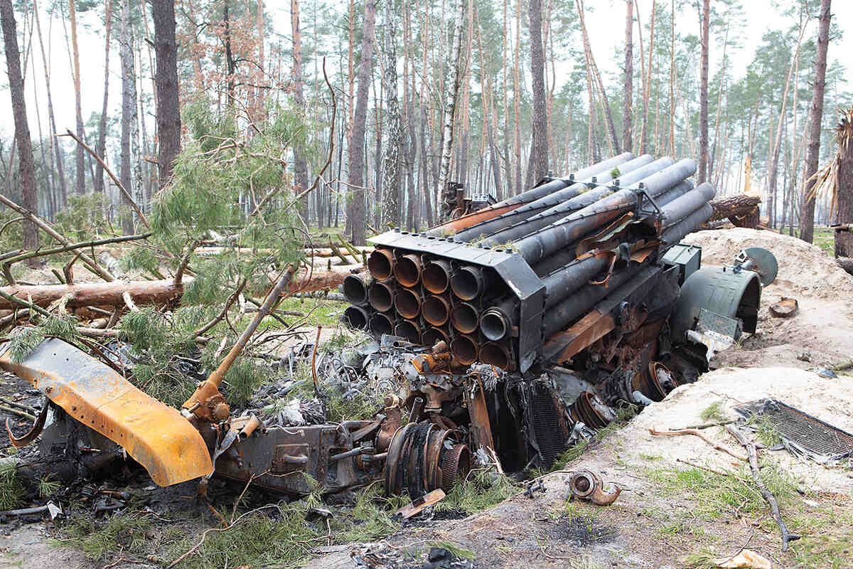 A russian rocket launcher lies abandoned in a forest in Ukraine