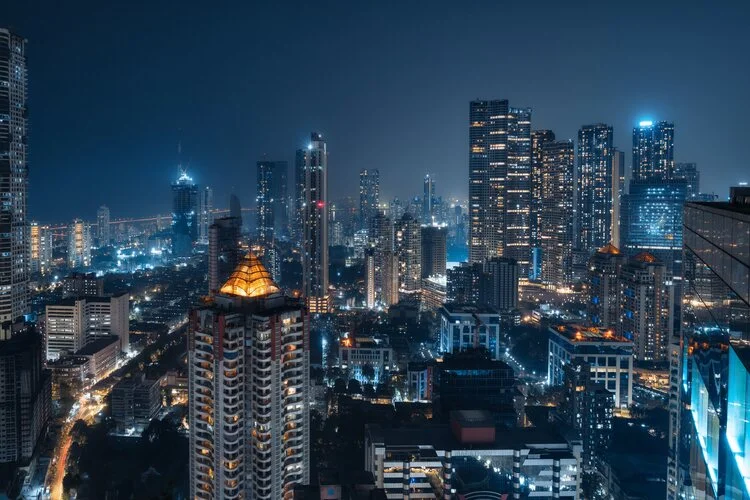 Skyline of Mumbai at night in India, one of the countries becoming wealthier.